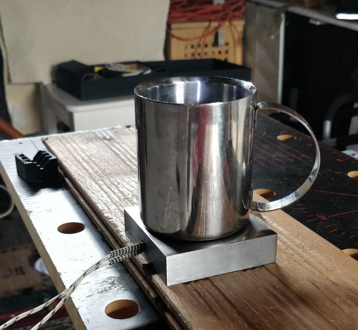 A cup on top of a steel block